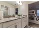 Bathroom with double sinks and a glimpse of a bunk room with bunkbeds at 481 Ocean Course Ave, Davenport, FL 33896