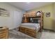 Charming bedroom features a sturdy bunk bed and rustic wooden dresser at 481 Ocean Course Ave, Davenport, FL 33896