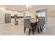 Elegant dining area adjacent to a modern kitchen with bar stool seating at 481 Ocean Course Ave, Davenport, FL 33896