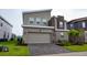 Contemporary two-story home featuring stone accents and a two-car garage at 481 Ocean Course Ave, Davenport, FL 33896