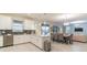 Open concept kitchen with stainless appliances flowing into dining and living areas at 481 Ocean Course Ave, Davenport, FL 33896