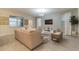 Bright living room with neutral tones, large windows, and stylish decor at 481 Ocean Course Ave, Davenport, FL 33896