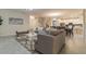 Large living room with a view of the kitchen, dining room and staircase at 481 Ocean Course Ave, Davenport, FL 33896