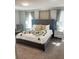 Bright main bedroom showcasing a stylish bed, neutral decor, and ample natural light at 481 Ocean Course Ave, Davenport, FL 33896