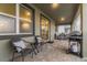 Covered patio with cozy seating, a table and a barbecue grill at 481 Ocean Course Ave, Davenport, FL 33896