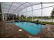 Beautiful pool featuring brick pavers, an attached spa, and peaceful lake views at 481 Ocean Course Ave, Davenport, FL 33896