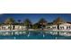 Resort-style pool area with lounge chairs, umbrellas, and palm trees illuminated at night at 481 Ocean Course Ave, Davenport, FL 33896