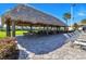 Thatched poolside cabana offers shaded seating with lounge chairs for sunny days by the pool at 481 Ocean Course Ave, Davenport, FL 33896