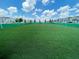 Well-maintained community soccer field with vibrant green turf, safety fencing, and blue sky at 481 Ocean Course Ave, Davenport, FL 33896