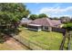 This backyard is spacious with a large tree, green grass, and a fenced perimeter for privacy at 4811 Doc Dr, St Cloud, FL 34771