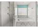 Bathroom showing tub, shower and block window for natural light at 4811 Doc Dr, St Cloud, FL 34771