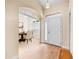 Bright foyer featuring hardwood floors, an arched entryway to the dining room, and a classic white front door at 4811 Doc Dr, St Cloud, FL 34771