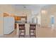Open kitchen with breakfast bar, white appliances, and views of the living area at 4811 Doc Dr, St Cloud, FL 34771