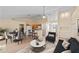Open concept living room with light wood floors, eat-in kitchen, and modern decor at 4811 Doc Dr, St Cloud, FL 34771