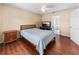 Bedroom with hardwood floors featuring ceiling fan, tv and access to the bathroom at 4811 Doc Dr, St Cloud, FL 34771