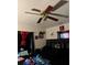 Bedroom with black bedding, decorative fan, and unique wall art, illuminated by natural light at 4834 Ute St, Orlando, FL 32819