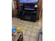 Entertainment center in living room featuring a flat screen tv and wood-look tile floors at 4834 Ute St, Orlando, FL 32819