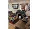 Cozy living room featuring brown leather furniture, tile floors, and an aquarium as a focal point at 4834 Ute St, Orlando, FL 32819