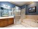Bathroom boasts a large shower, soaking tub, and vanity with neutral decor at 4911 Lazy Oaks Way, St Cloud, FL 34771