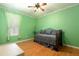 Charming bedroom featuring a daybed, hardwood floors, and soft natural light at 4911 Lazy Oaks Way, St Cloud, FL 34771