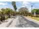 View of the gated entrance to the community with mature trees and landscaping at 4911 Lazy Oaks Way, St Cloud, FL 34771