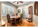 Bright dining room features wood floors, a window and decorative shutters at 4911 Lazy Oaks Way, St Cloud, FL 34771