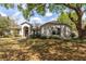 Charming single-story home with lush landscaping, mature trees and inviting curb appeal at 4911 Lazy Oaks Way, St Cloud, FL 34771