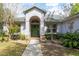 Charming home with a green front door, decorative wreath, and a well-manicured lawn and landscaping at 4911 Lazy Oaks Way, St Cloud, FL 34771