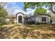 Charming single-story home with a well-manicured front yard and mature trees at 4911 Lazy Oaks Way, St Cloud, FL 34771