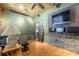 Stylish game room features wood floors, unique lighting, and built in media at 4911 Lazy Oaks Way, St Cloud, FL 34771