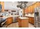 Bright kitchen featuring stainless steel appliances, tile floors, and an island at 4911 Lazy Oaks Way, St Cloud, FL 34771