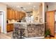 Charming kitchen with an island, tile backsplash, bar seating and stainless appliances at 4911 Lazy Oaks Way, St Cloud, FL 34771