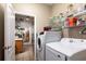 Efficient laundry room with new washer and dryer adjacent to an open-concept kitchen at 4911 Lazy Oaks Way, St Cloud, FL 34771