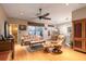 Open-concept living room with hardwood floors, a ceiling fan, and a view of the dining area at 4911 Lazy Oaks Way, St Cloud, FL 34771