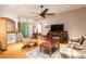 Comfortable living room featuring hardwood floors, fireplace, and ample seating at 4911 Lazy Oaks Way, St Cloud, FL 34771