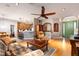 Spacious living room with hardwood floors, seamlessly connected to the kitchen and dining area at 4911 Lazy Oaks Way, St Cloud, FL 34771