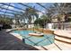 Spectacular pool area with a central island, tropical accents, and comfortable lounging spaces at 4911 Lazy Oaks Way, St Cloud, FL 34771