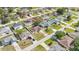 A bird's-eye view shows a quiet neighborhood with neatly arranged homes and green lawns at 50 Sawfish Ct, Kissimmee, FL 34759