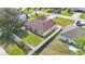 Aerial view of a home showcasing a green lawn, white fencing, and lush green trees at 50 Sawfish Ct, Kissimmee, FL 34759
