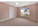 A bright bedroom features a ceiling fan and a window overlooking a well-kept lawn at 50 Sawfish Ct, Kissimmee, FL 34759