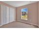 Bright bedroom features a closet and a window offering a view of the neighborhood at 50 Sawfish Ct, Kissimmee, FL 34759