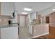 A bright kitchen featuring white cabinetry, stainless appliances and granite countertops with breakfast bar seating at 50 Sawfish Ct, Kissimmee, FL 34759