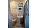 Compact bathroom with pedestal sink, toilet, and classic vanity mirror at 50989 Highway 27 # 210, Davenport, FL 33897