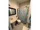 Full bathroom with stand up shower and floral shower curtain at 50989 Highway 27 # 210, Davenport, FL 33897