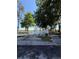 A private ramp entrance, surrounded by trees and a view of the lake beyond the gate at 50989 Highway 27 # 210, Davenport, FL 33897