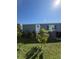 Charming home exterior featuring a well-manicured lawn with plants, siding, and brick pathway at 50989 Highway 27 # 210, Davenport, FL 33897