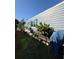 View of home with siding and blue shutters surrounded by manicured garden with lush greenery and vegetation at 50989 Highway 27 # 210, Davenport, FL 33897