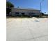 Exterior view of two-story apartment building with well-maintained landscaping and ample parking at 50989 Highway 27 # 210, Davenport, FL 33897
