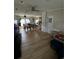 Spacious living and dining area with hardwood floors and neutral wall tones, creating an open and inviting atmosphere at 50989 Highway 27 # 210, Davenport, FL 33897