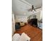Open living space with hardwood floors, large ceiling fan, comfortable seating arrangement, and entertainment center at 50989 Highway 27 # 210, Davenport, FL 33897